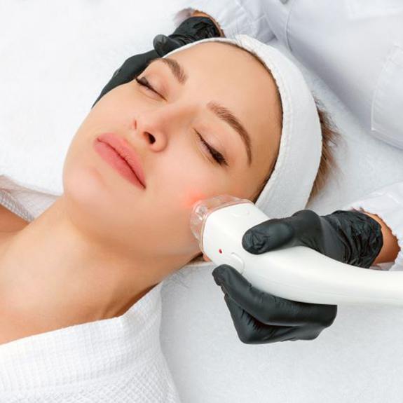 Woman relaxing during laser treatment in Medspa