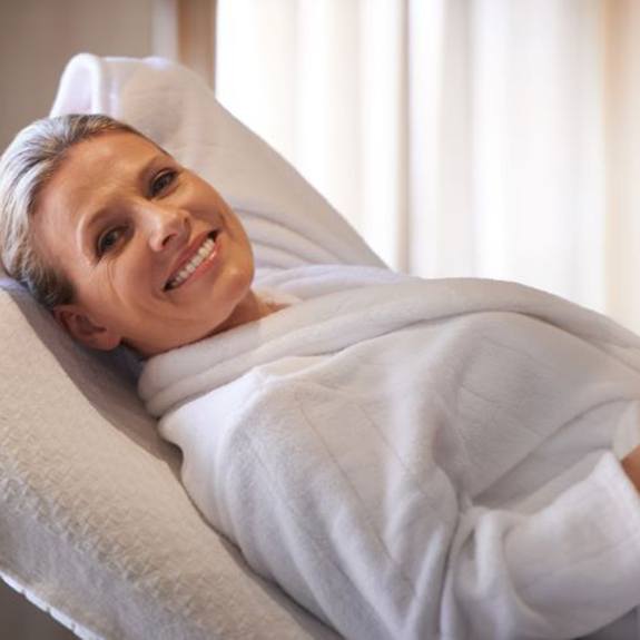 Relaxed medspa patient wearing white robe