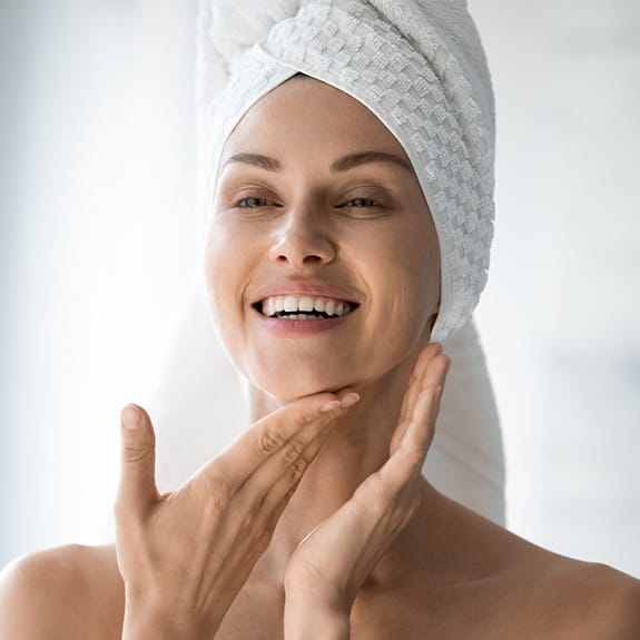 Woman completing her daily skincare routine