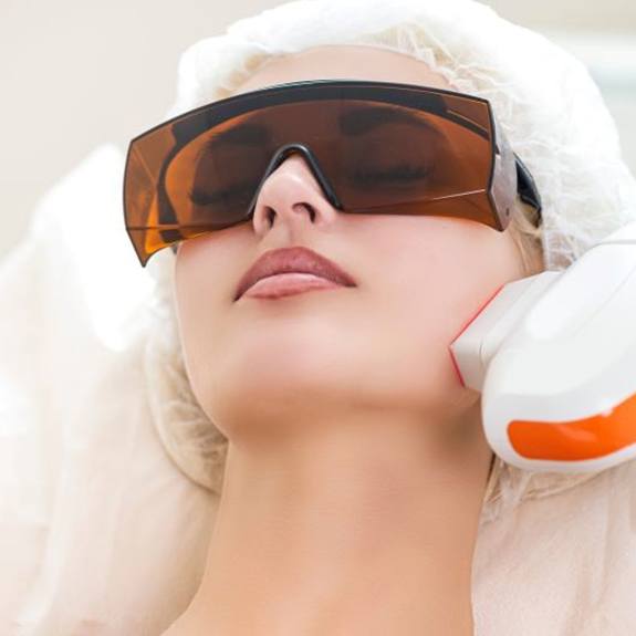 Woman relaxing during medical laser treatment