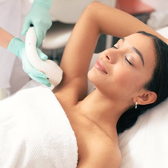 Woman relaxing during laser hair removal
