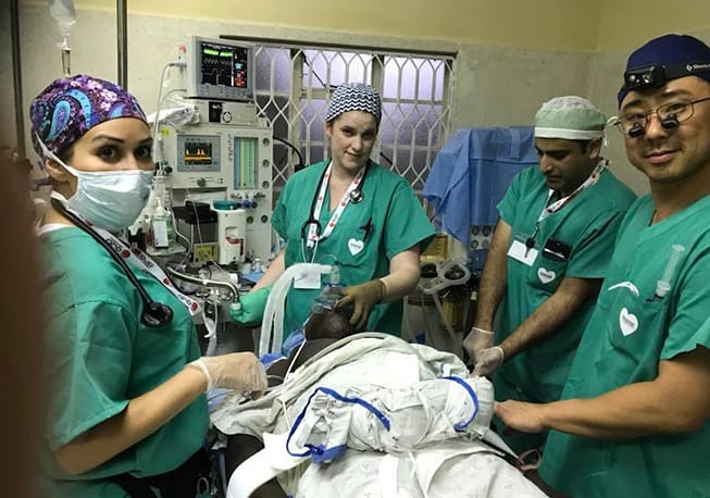 Group of doctors treating patient on mission trip
