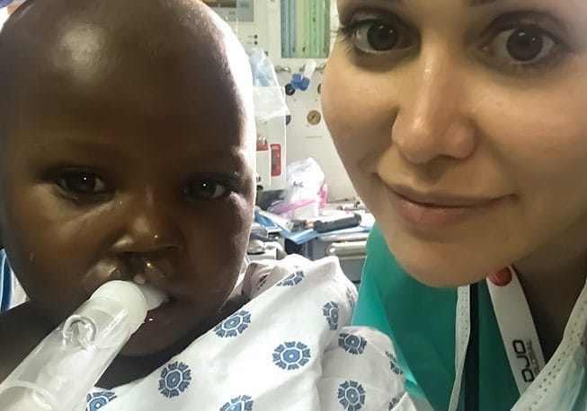 Doctor and child smiling together after treatment