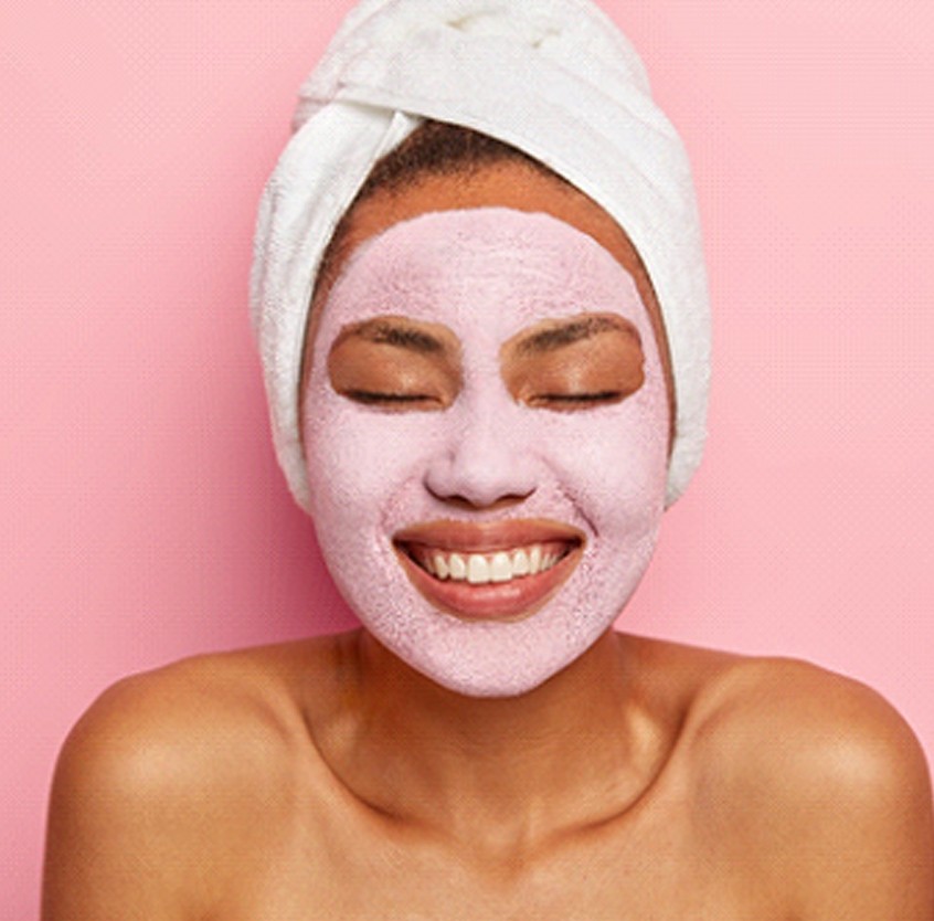 Woman smiling during facial treatment