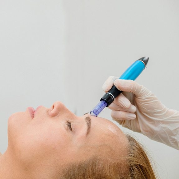 Woman with closed eyes enjoying her professional microneedling treatment