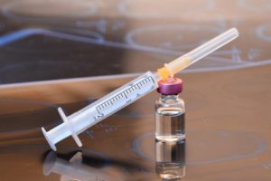 Vial and syringe of BOTOX in Houston sitting on tabletop